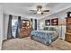 Cozy bedroom featuring carpeted floor, and dresser with decorative pillows and curtains at 10404 Hawk Ct, Riverview, FL 33578