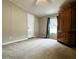 Neutral bedroom with plush carpet, large window, and ample closet space at 10404 Hawk Ct, Riverview, FL 33578
