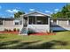 Charming home with a screened in porch and well-manicured lawn at 10404 Hawk Ct, Riverview, FL 33578