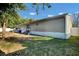 Home exterior shows spacious, grassy backyard and an exterior view of the back of the home at 10404 Hawk Ct, Riverview, FL 33578