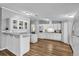 Modern kitchen featuring white cabinets, stainless steel appliances, and a breakfast bar area at 10404 Hawk Ct, Riverview, FL 33578