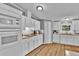 Bright kitchen with white cabinets, updated appliances, and wood-look flooring for a modern touch at 10404 Hawk Ct, Riverview, FL 33578