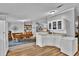 Open concept kitchen and dining area featuring modern appliances, white cabinets, and ample counter space at 10404 Hawk Ct, Riverview, FL 33578