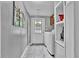 Bright laundry room featuring a front-load washer and dryer, tile floors, and ample storage cabinets at 10404 Hawk Ct, Riverview, FL 33578