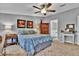 Cozy main bedroom with ensuite bathroom, neutral decor, and a ceiling fan for added comfort at 10404 Hawk Ct, Riverview, FL 33578