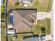 Aerial shot displays the home's roof, driveway, and enclosed pool with a fenced backyard at 12442 Curry Dr, Spring Hill, FL 34609