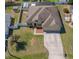 An aerial view of a single-Gathering home with a well-maintained yard and long driveway at 12442 Curry Dr, Spring Hill, FL 34609