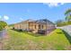 A spacious backyard featuring a screened lanai, hot tub, and lush lawn at 12442 Curry Dr, Spring Hill, FL 34609