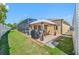 Enjoy an outdoor oasis with a screened pool, covered patio, and lush green lawn at 12442 Curry Dr, Spring Hill, FL 34609