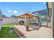 Relax in this backyard featuring a screened pool, grill, and covered outdoor seating area at 12442 Curry Dr, Spring Hill, FL 34609
