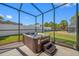 A stunning hot tub with a view of the lawn and the privacy fence in the backyard at 12442 Curry Dr, Spring Hill, FL 34609