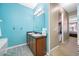 Bathroom featuring a double sink vanity with decorative mirror, and a doorway to the main bedroom at 12442 Curry Dr, Spring Hill, FL 34609