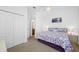 Bedroom featuring neutral carpet, ceiling fan, double closet, and doorway to the bathroom at 12442 Curry Dr, Spring Hill, FL 34609