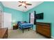 Bedroom featuring a ceiling fan, window, and light blue accent wall at 12442 Curry Dr, Spring Hill, FL 34609