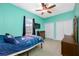 Bedroom featuring a ceiling fan, double closet, and light blue accent wall at 12442 Curry Dr, Spring Hill, FL 34609