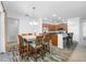 Bright dining area featuring a long dining table and a view of the modern kitchen at 12442 Curry Dr, Spring Hill, FL 34609