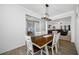 Bright dining room features a wood table with seating for six and views into the living room at 12442 Curry Dr, Spring Hill, FL 34609