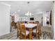 Open dining area with wood table and seating, flowing into the living room and kitchen at 12442 Curry Dr, Spring Hill, FL 34609