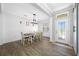 Inviting dining room boasts a modern light fixture and easy access to the main entrance at 12442 Curry Dr, Spring Hill, FL 34609