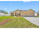 Charming single-story home with a well-manicured lawn and a two-car garage at 12442 Curry Dr, Spring Hill, FL 34609