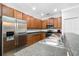 Kitchen featuring stainless steel appliances, stone countertops, and wood cabinets at 12442 Curry Dr, Spring Hill, FL 34609