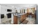 Open layout with kitchen island offering a view of the living and dining areas at 12442 Curry Dr, Spring Hill, FL 34609