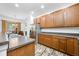 Well-lit kitchen area featuring stainless steel appliances, wood cabinets, and stone countertops at 12442 Curry Dr, Spring Hill, FL 34609
