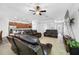 Open-concept living room featuring leather furniture and neutral color scheme with view of kitchen at 12442 Curry Dr, Spring Hill, FL 34609