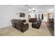 Spacious living room featuring plush leather seating and natural light, designed for comfortable living at 12442 Curry Dr, Spring Hill, FL 34609