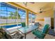 Covered patio with a dining table, ceiling fans, and views of the screened pool and backyard at 12442 Curry Dr, Spring Hill, FL 34609
