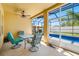 Enjoy outdoor dining on a covered patio with a ceiling fan and views of the screened pool at 12442 Curry Dr, Spring Hill, FL 34609