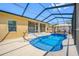 A stunning screened in pool, with clear blue water and an outdoor gazebo with seating at 12442 Curry Dr, Spring Hill, FL 34609