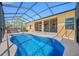 A stunning screened in pool, with clear blue water and a hot tub at 12442 Curry Dr, Spring Hill, FL 34609