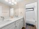 Bathroom featuring double sinks, white cabinetry, and a separate shower/tub area for a spa-like experience at 12929 Prestwick Dr, Riverview, FL 33579