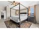 Comfortable Primary bedroom with a four-poster bed, side tables, and large windows for natural light at 12929 Prestwick Dr, Riverview, FL 33579