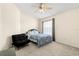 Simple bedroom offering a cozy bed, sleek black futon chair, and ceiling fan at 12929 Prestwick Dr, Riverview, FL 33579