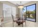 Cozy dining area featuring a glass table and four decorative chairs, with a sliding door to the outdoors at 12929 Prestwick Dr, Riverview, FL 33579