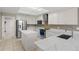 Modern kitchen with white cabinets, stainless steel appliances, a center island, and marble countertops at 12929 Prestwick Dr, Riverview, FL 33579