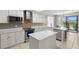 Well-equipped kitchen featuring stainless steel appliances, marble countertops, and a view of the dining area at 12929 Prestwick Dr, Riverview, FL 33579