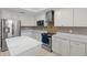 Bright kitchen with stainless steel appliances, marble countertops, and white cabinetry at 12929 Prestwick Dr, Riverview, FL 33579