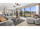 Bright living room featuring tile floors, comfortable seating, and a large window overlooking a serene backyard at 12929 Prestwick Dr, Riverview, FL 33579