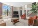 Elegant living room with large windows, neutral tones, and a staircase in the background at 12929 Prestwick Dr, Riverview, FL 33579