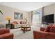 Comfortable living room featuring a large window with natural light, neutral tones, and plush seating at 12929 Prestwick Dr, Riverview, FL 33579