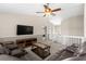 Comfortable living room with plush leather sofas, a modern TV, and neutral tones throughout the space at 12929 Prestwick Dr, Riverview, FL 33579