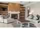 Inviting living room showcasing a fireplace, decorative shelving, and comfortable seating arrangement at 12929 Prestwick Dr, Riverview, FL 33579
