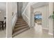Carpeted staircase leading to the upper level with tiled floors, light walls, and views of the backyard at 12929 Prestwick Dr, Riverview, FL 33579