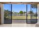 View from the home's interior, highlighting the serene backyard pond and lush landscaping at 12929 Prestwick Dr, Riverview, FL 33579