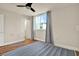 Bright bedroom featuring hardwood floors, ceiling fan, and a door that leads to another room at 1301 S Howard Ave # B24, Tampa, FL 33606