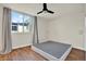 This bedroom has a ceiling fan, hardwood floors, and curtains framing the bright window at 1301 S Howard Ave # B24, Tampa, FL 33606