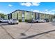 Two-story apartment building with ample parking and lush landscaping on a sunny day at 1301 S Howard Ave # B24, Tampa, FL 33606